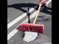 Filling and heating thermoplastic to repair the potholes of a road