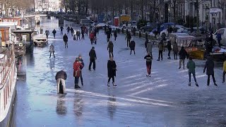 Dutch ice skaters take advantage of frozen canals and lakes amid northern Europe's deep freeze