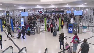 Travelers at Hartsfield-Jackson Atlanta International Airport talk flying on Christmas Eve