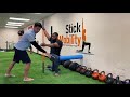 Half-Kneeling Monkey Hang with Thoracic Rotation - Stick Mobility Exercises