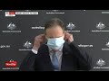 Australia's Health Minister struggles with a face mask