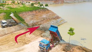 Amazing bulldozer and dump trucks filling land into the big pond