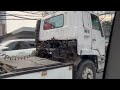 dark white isuzu 810 tractor head with white container in granada street