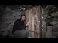 a man is restoring a stone hut in the mountains. spends the night alone. without words.