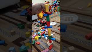 Building a tower with kids wood blocks. Making by GA.