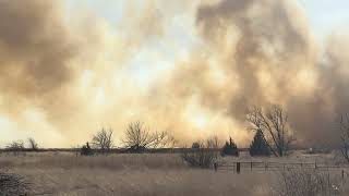 Firefighters battling large grass fire with strong wind gusts south of Mitchell