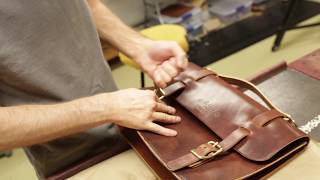 Leather craftsman making a satchel