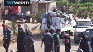 The War in Syria: Rebel fighters and their families evacuate Homs