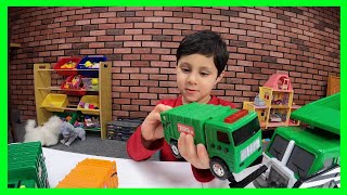 Wali Playing with Different Toy Garbage Trucks