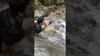 Rocky waterfall challenge: triumph amidst slip and fall