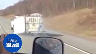 Clueless driver drags a U-Haul trailer on its side down a highway