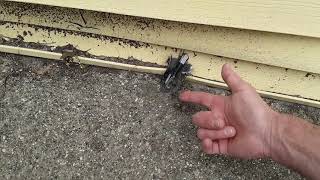 Exposed UV rated wire not in conduit with damaged cut wire at exterior - NOT safe in driveway areas