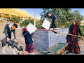 Nomadic life: painting the walls of a nomadic house: repairing the roof of a nomadic couple's house