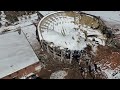 drone view of mobile civic center roof collapsing under snow