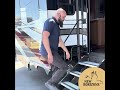 austin demonstrates new horizons rv s standard entry steps shown with optional strut assist.