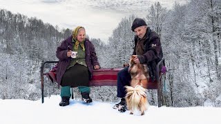 Happy old age of an elderly couple in a mountain village in winter far from civilization