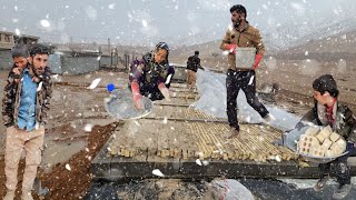 A cold, stormy, rainy day: Ali's nomadic family struggles to finish building the roof of their house