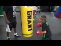 Jeff Mayweather instructing a little kid on the heavy bag