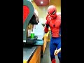 spiderman teaching a subway customer how to use a soda machine