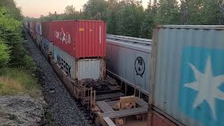 A long and heavy eastbound grainer stops for eastbound intermodel 104 to pass at Ingolf. 8/2/24