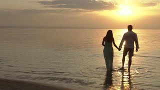 Couple Walking Into Ocean Stock Video