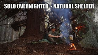 solo bushcraft overnighter in the winter - natural shelter