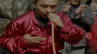 Kung fu master bizarrely blows up tire with his nose