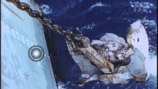 Anchor being pulled up a ship underway in the Pacific Ocean during World War II. HD Stock Footage