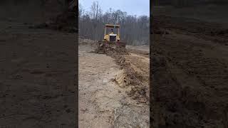 cat d4h clearing some mud for the drill rig