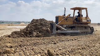 Amazing bulldozer pushing rock with dirt filling lake operator Komatsu D68E