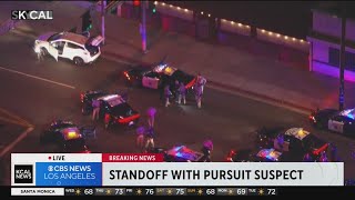 Stolen vehicle's tire ripped off by spike strip during lengthy pursuit with armed suspect