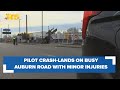 Pilot crash-lands on busy Auburn road, escapes with only minor injuries