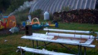 homemade gun blasting an apple at a cinder block