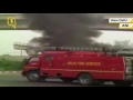 fire fighters douse flames in dtc bus in the middle of a road