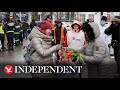 Romanians greet refugees with International Women's Day flowers