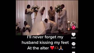 Husband bows to wife and kisses her feet at the altar