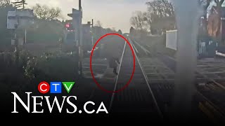 Woman has near miss with train at level crossing in the U.K.