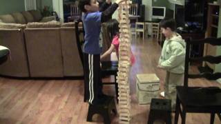 Kids Building Tall Tower with Kapla Blocks