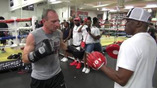 Floyd Mayweather Sr. teaching the shoulder roll to some novices inside the Mayweather Boxing Club