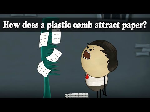 Why do pieces of paper stick to a comb?