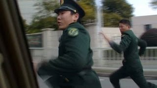 China security officers chase CNN crew
