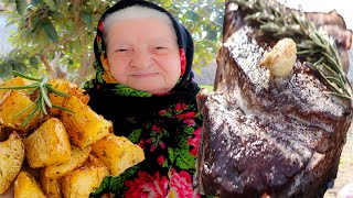 Grandmother cooks steak on the fire