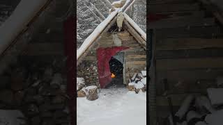 cozy fire during winter storm in my bushcraft shelter