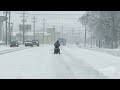 01 06 2025 louisville ky man riding scooter down snowy road