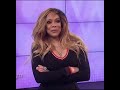 Stan Twitter: Wendy Williams standing with her arms crossed while a crowd cheers her on