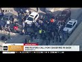 a frustrated 110 freeway driver fights with protestors as rush hour traffic is stopped on the roadwa