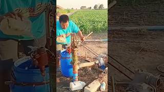 The process of pumping water from a well