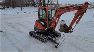 Is a Mini Excavator good at plowing snow?