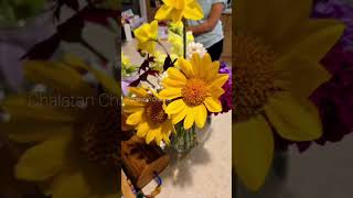 Flowers in a vase and sprout vegetable in the necessary tray