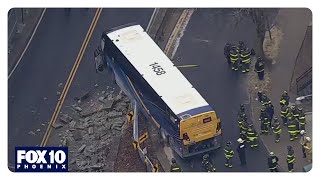 Crash sends bus dangling over New York overpass